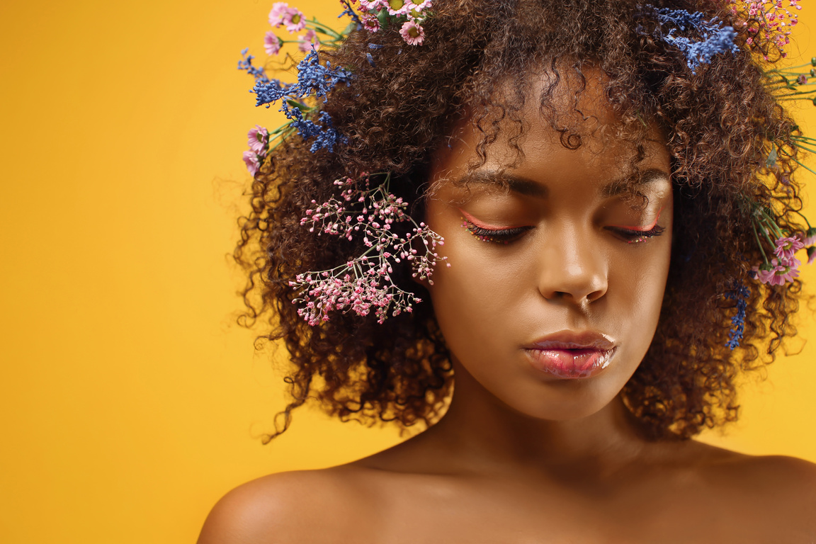 Beautiful Afro Woman with Flowers in Hair